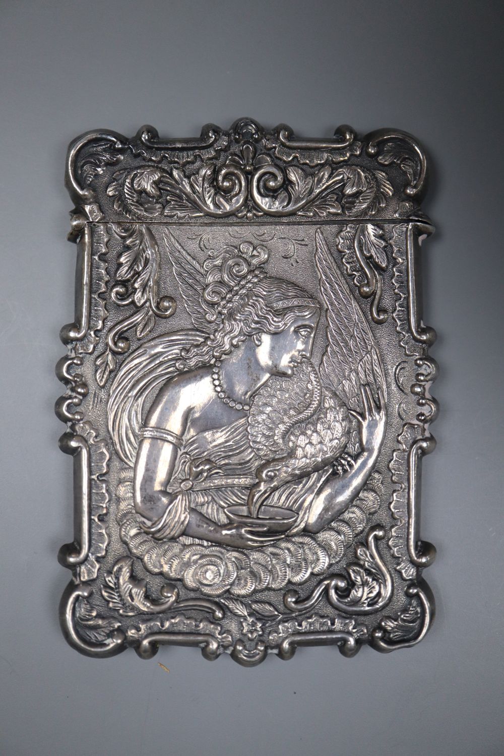 A 19th century white metal card case, the front and back embossed with Ganymede & the Eagle and cathedral, unmarked,